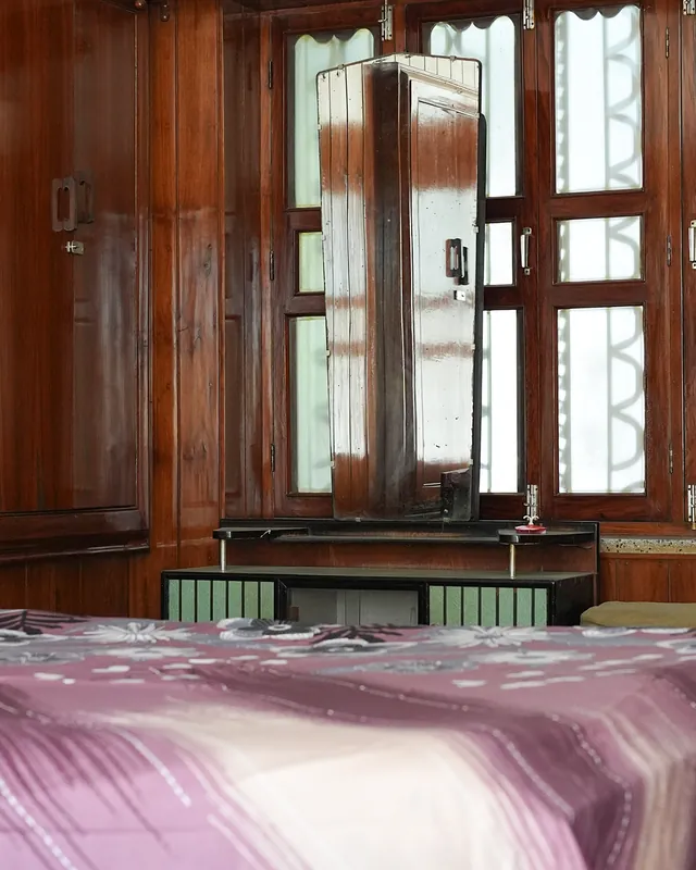 Wood-panelled guest room with a dressing mirror